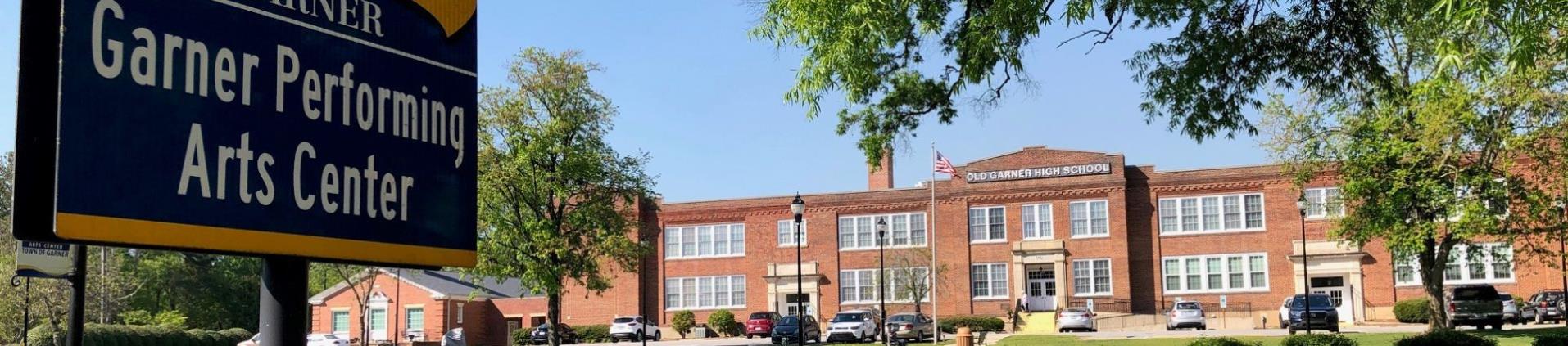 Brick exterior of 2 story school front, formerly Garner High School, now the Garner Performing Arts Center